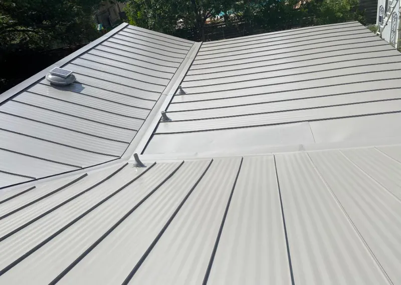 Solar attic fan installed on a metal roof for Roof Ventilation in West Pensacola
